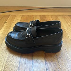 Women’s size 7.5 black leather loafers with silver hardware. Brand new.